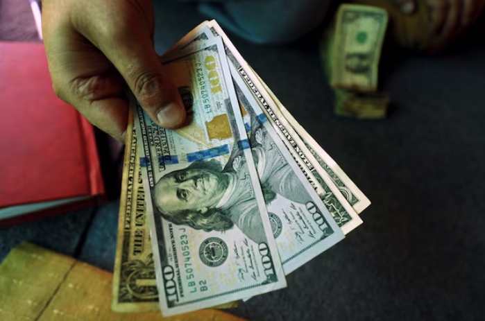 Dollar Edges Down Ahead of Data, Set for First Monthly Drop in 2024